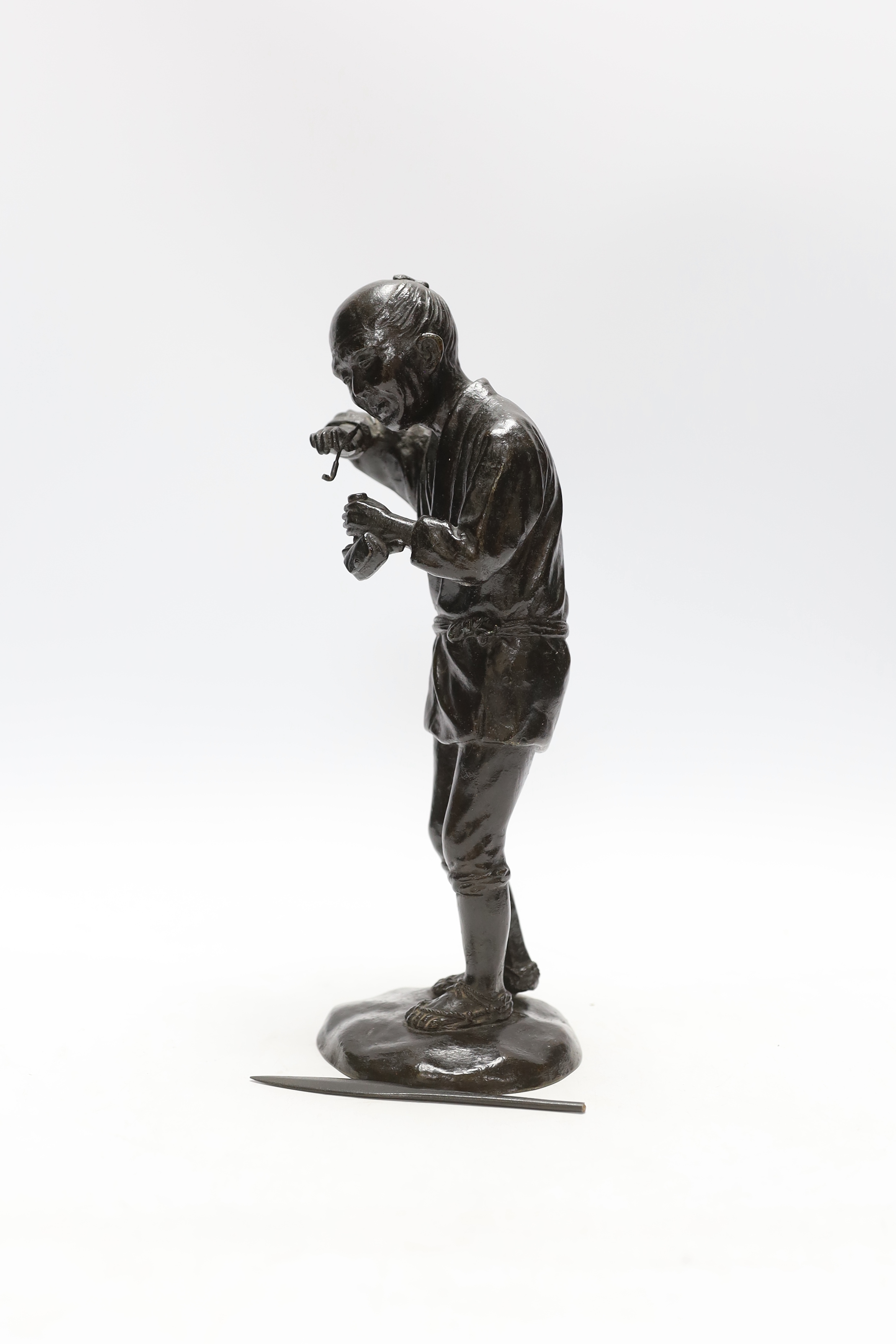 A Japanese Meiji period bronze of a pipe smoker, 29cm high